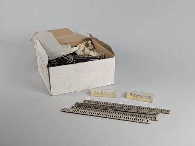 a box with a bunch of pins in it on a table