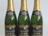 three bottles of champagne sitting on top of a white table