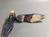 pair of black shoes with a red stripe on the sole