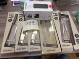 several boxes of knives on a table with a person sitting in front of them