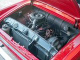 a red car with its hood open and the engine in the trunk