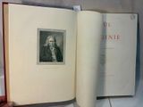 someone is holding a book with a picture of a man in a suit