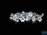 a close up of a bunch of diamonds on a black surface