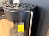 a coffee maker that is sitting on the floor