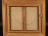 an image of a picture frame with a picture hanging on a wooden easel