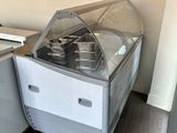 an ice cream machine sitting in the corner of a kitchen