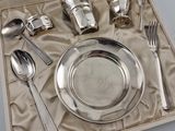 a silver plate and silverware set in a box