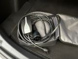 a car trunk with a charger and a cord in it