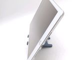 a tablet computer sitting on a stand on a white surface