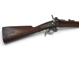 un vieux fusil avec un canon en bois et des garnitures en laiton