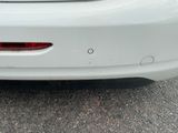 a white car that is parked in the parking lot