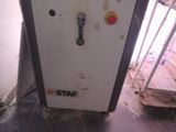 a white refrigerator with a red and yellow button on it