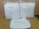 three bags of toilet paper sitting on top of a cardboard box