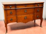a wooden dresser with many drawers on it