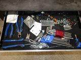 many tools in a tool box on the floor