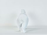 white ceramic elephant figurine standing on a white surface