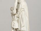a statue of a woman and a child on a table