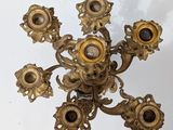 a gold colored chandelier that has five lights on it