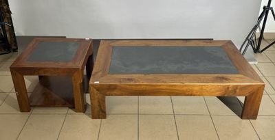 two wooden tables with glass tops on a tiled floor in a room