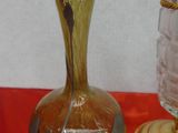 two glass vases sitting on a red table