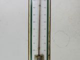 a thermometer hanging on a wall in a room