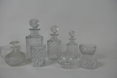 a lot of glass bottles and vases sitting on a table