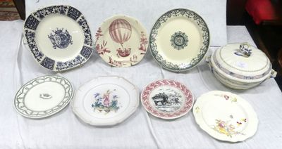 many plates and bowls on a table with a white table cloth