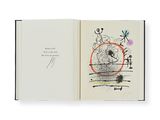 an open book with a drawing of a cat and a bird on it