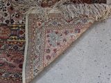 a cat that is laying on a rug on the floor