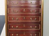 a tall chest of drawers with brass hardware on it
