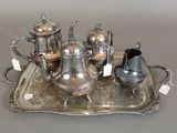 a silver tray with a silver tea set on it