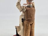 a figurine of a man with a knife in his hand