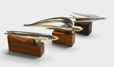 three surfboards on a wooden stand on a white background