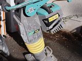 a blue and yellow machine that is sitting on the ground