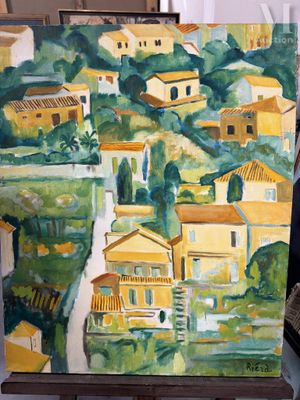 un tableau représentant un village, posé sur un chevalet dans une pièce