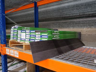 a shelf with several boxes of books on it in a warehouse