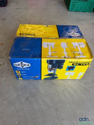 a box of beer sitting on the floor next to a pile of boxes