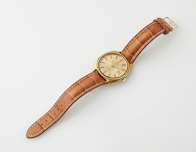 a close up of a watch on a white surface with a white background