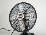 a black fan that is on a white table