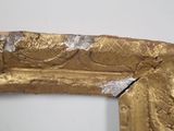 a picture of a gold frame with a picture of a woman on it