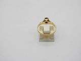 a close up of a gold ring on a white surface