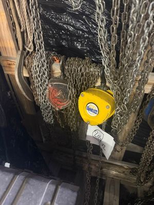 des chaînes suspendues au plafond d'un immeuble à l'aide d'un crochet jaune