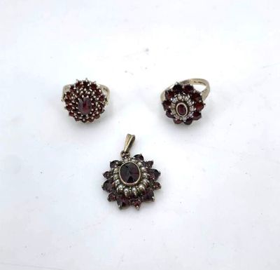 three silver and garnet stone rings and a garnet stone ring
