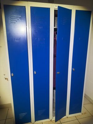 several blue lockers are lined up in a row in a bathroom