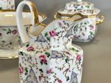 three pieces of porcelain tea and coffee set on a table