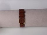 a watch that is sitting on top of a roll of paper