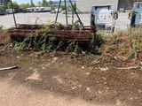 a pile of wood sitting on the ground next to a fence