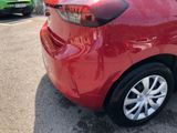 a red car parked in a parking lot with other cars in the background