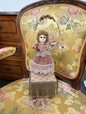 a doll that is sitting on a chair in a room