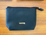 a black purse and a wallet sitting on a table